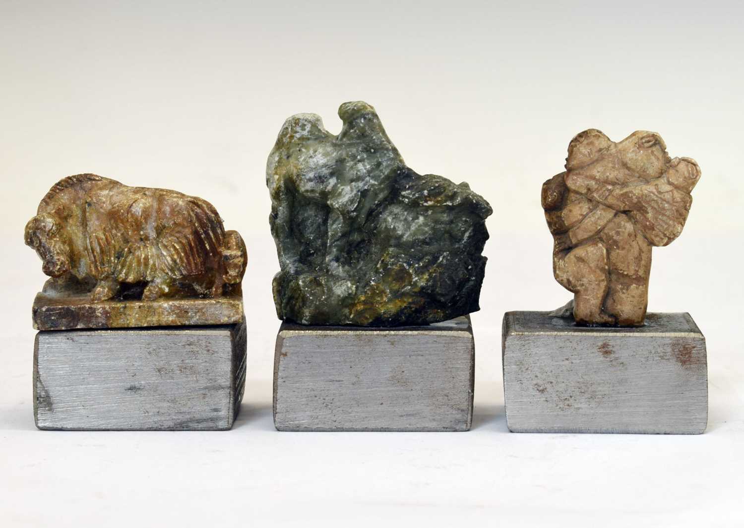 Three carved soapstone figures