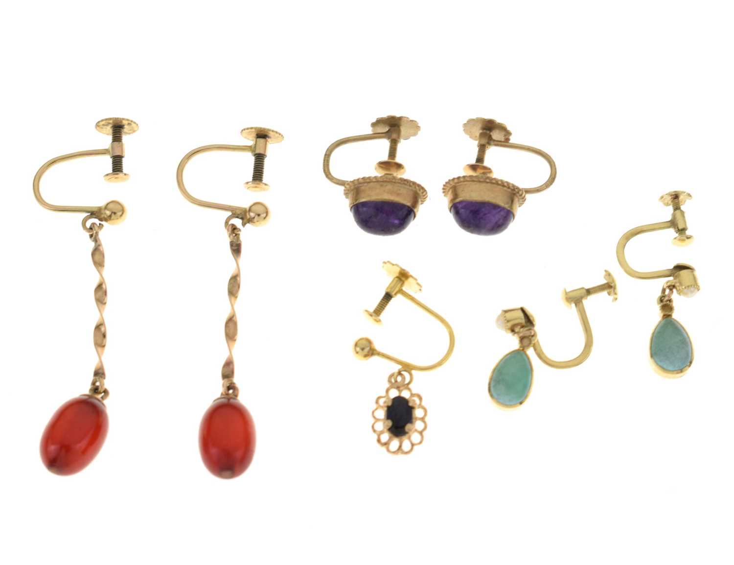 Three pairs of earrings including a pair of 'cherry amber' earrings