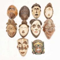 Group of ten carved wall hanging masks