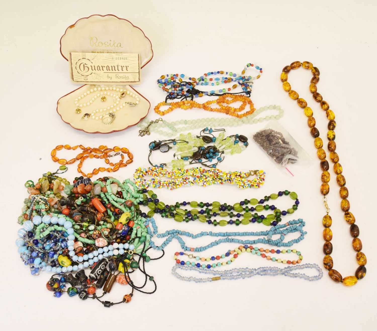 Costume jewellery to include amber, bone, garnet, hardstone bead necklaces and cased simulated pearl