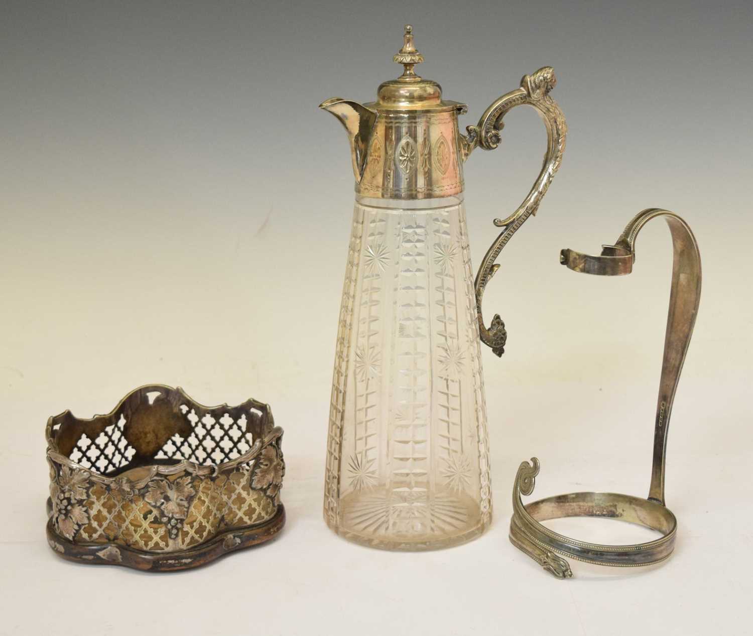 Victorian cut glass claret jug, a silver plated bottle coaster, and a wine bottle carrier