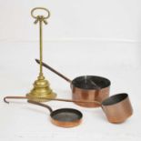 Gilt metal doorstop and three copper pans