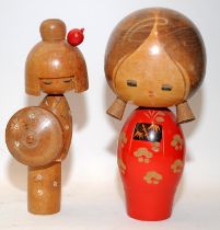 Two vintage Japanese Kokeshi wooden dolls, the largest being 21cms tall