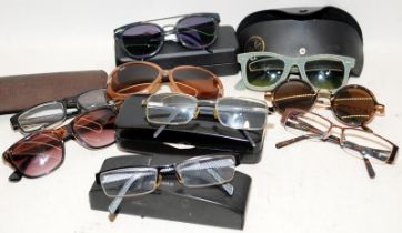 A collection of sunglasses and reading glasses