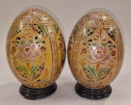 Pair of porcelain eggs on wood stands