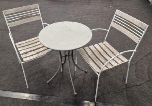 Contemporary outdoor bistro dining table with two chairs.
