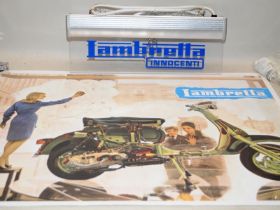 A Lambretta light up sign and Lambretta poster