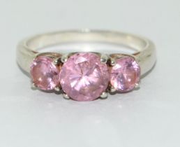 A 925 silver and pink topaz trilogy ring Size P