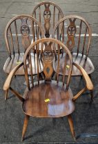 Four vintage Ercol blue label "Fleur De Lys" chairs to include a carver.