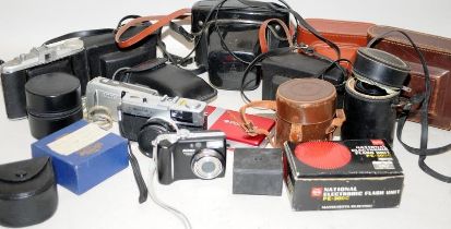 A carton containing a quantity of vintage cameras and accessories to include an Olympus Trip