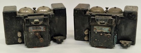 A pair of vintage bakelite field telephones (no handsets).