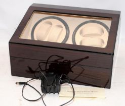 Automatic watch winder with 4 winding heads and storage space for an additional 6 watches.