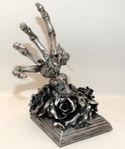 Sculptural Gothic black rose with skeletal hand bottle holder cast in metal. 28cms tall