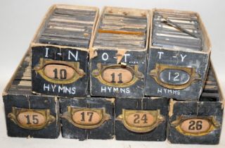 100's of antique magic lantern slides in numbered boxes. Religious texts/hymns/images. 7 boxes