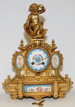 Antique French ormolu striking mantel clock featuring hand painted porcelain panels with a cherub