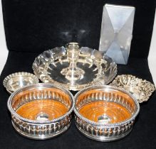 A collection of silver plated items including wine coasters, bon bon dishes and a candle nightstick