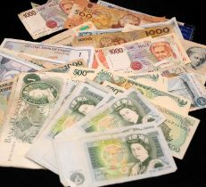 A collection of world banknotes including GB £1 notes