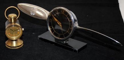 Two vintage desk clocks, an Art Deco chrome example in the form of a propeller and another in the