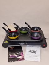 A come dine with me Party Wok with Pans and wooden utensils and manuals.