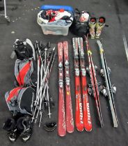 A cage containing large selection of Skis, ski poles, ski boots and clothing (cage not included).