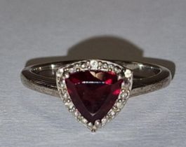 A 925 silver and garnet heart ring Size N