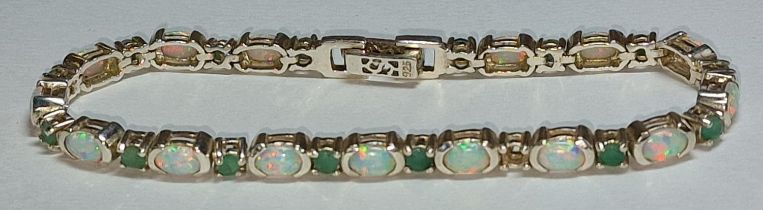 An opal and emerald silver bracelet.