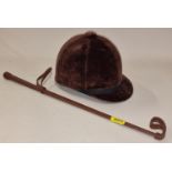 A Super Beaufort horse riding helmet size 7/57 together with a riding crop.