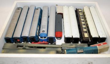 A tray containing a quantity of loose OO gauge rolling stock including a Leopold gun carriage