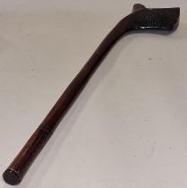 A carved wooden throwing war club.