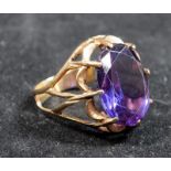 A 14ct gold vintage cocktail ring with purple stone.