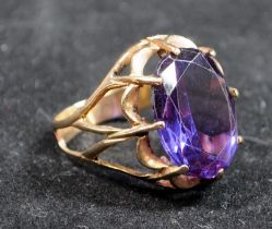A 14ct gold vintage cocktail ring with purple stone.
