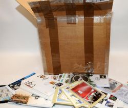 Box containing a very large quantity of Royal Mail First Day Covers and postcard stamps