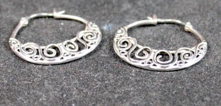 A pair of ornate 925 silver creole earrings.