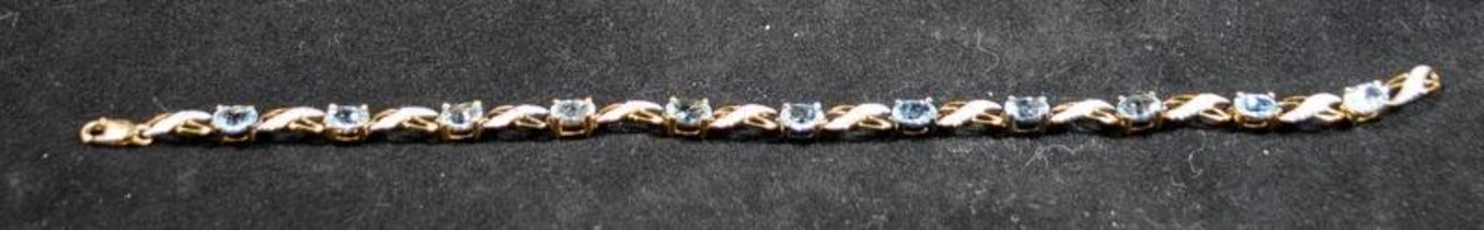 9ct gold diamond and blue topaz bracelet, boxed. 6.4g