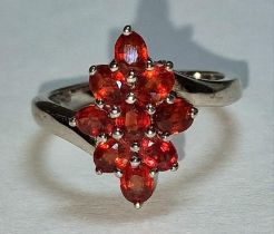 A faceted garnet 925 silver flower ring Size N.