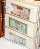 An album of world banknotes sorted alphabetically: Iran to Philippines