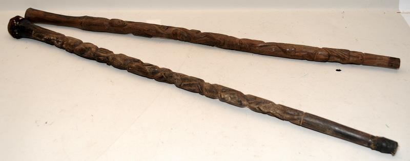 Two early African carved hardwood walking canes, each around 85cms long