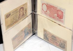 An album of world banknotes sorted alphabetically: Afghanistan to Fiji