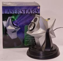 A boxed Laser Stars projector light together with a picture.