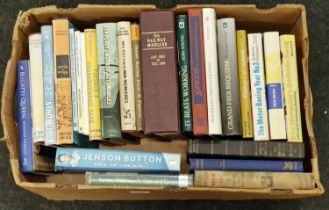 A box of vintage and modern automobilia related books.