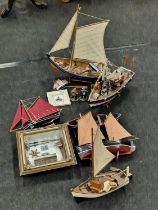 A collection of wooden boat models etc.