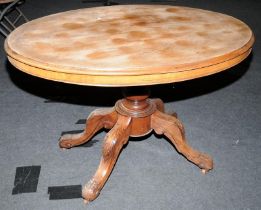 A vintage oak tilt top oval dining table 115cm wide 75cm tall.