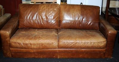 A contemporary tan leather three seater settee 70x190x95cm.