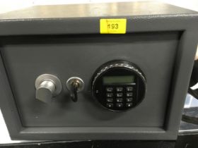 An electronic combination safe with keys and paperwork.