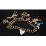 9ct gold charm bracelet with padlock clasp and safety chain attached. includes 6 charms. 24.7g