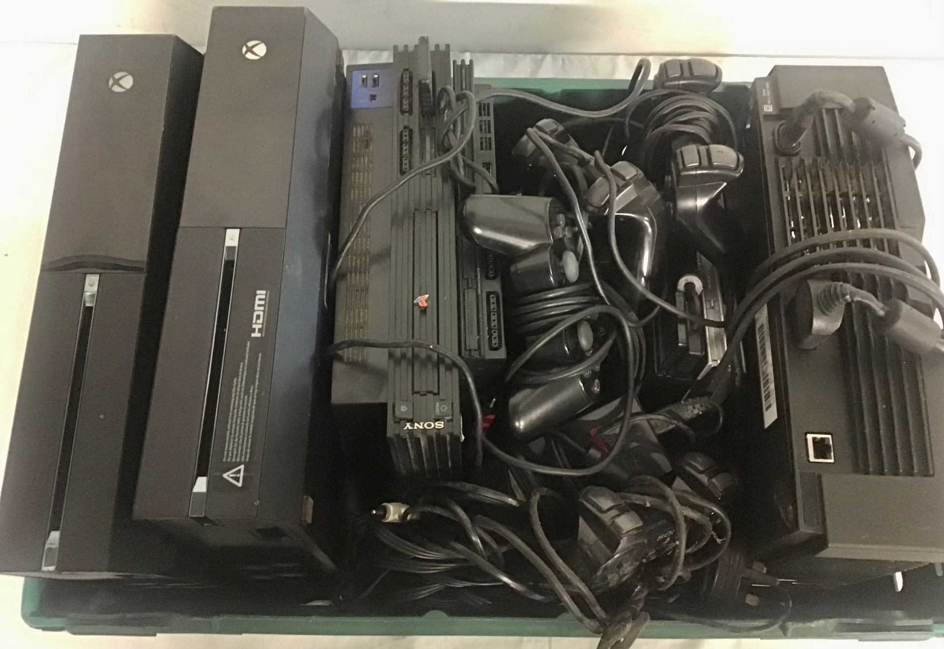 BOX OF VARIOUS GAMING CONSOLES AND CONTROLLERS. This box houses a total of 6 devices to include Xbox