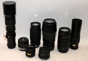 A collection of SLR camera lenses to include Canon and Nikon examples