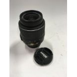 A Nikon AF-S fit DX18-55 1:3.5-5.6G lens with front and rear caps. (23)