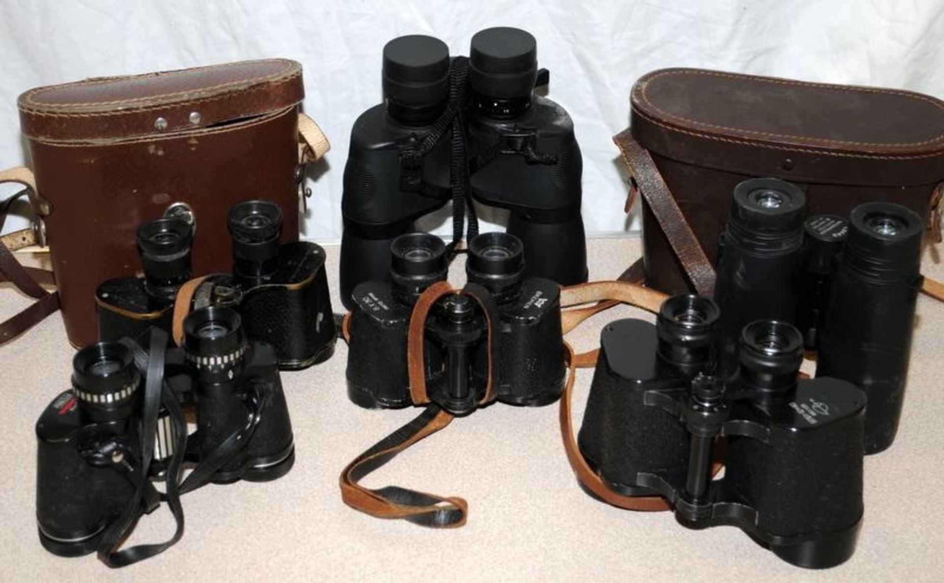 Collection of binoculars including vintage WWII examples.
