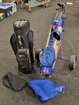 A Nike golf club bag together with a vintage set of golf clubs in a Browning bag and a golf trolley.